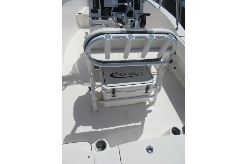 Slide: The Image of 2023 Robalo R180 Center Console boat interior with rod holders and storage compartment. - 19
