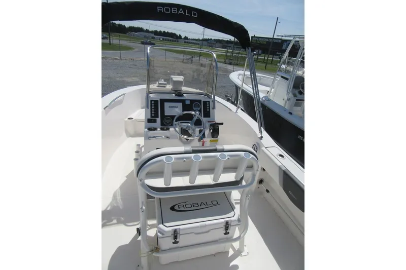 Slide: The Image of 2023 Robalo R180 Center Console boat interior with steering wheel and controls. - 20