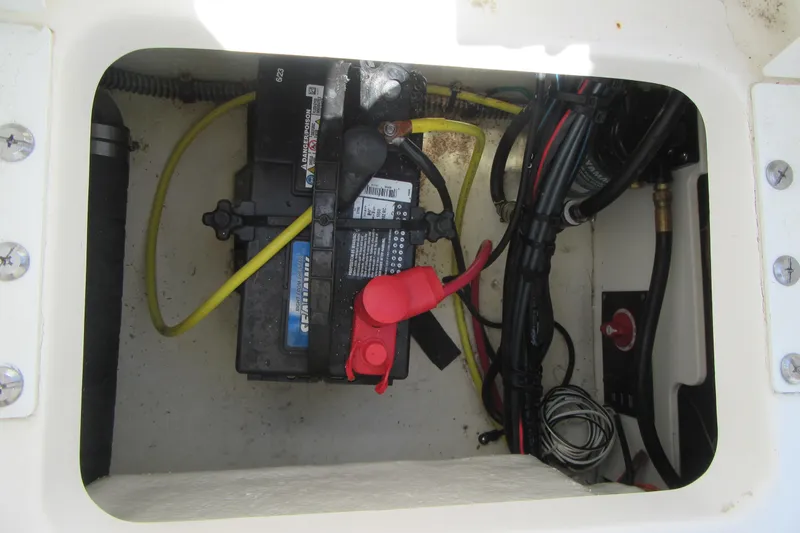 Slide: The Image of 2023 Robalo R180 Center Console battery compartment with wiring and connections. - 21
