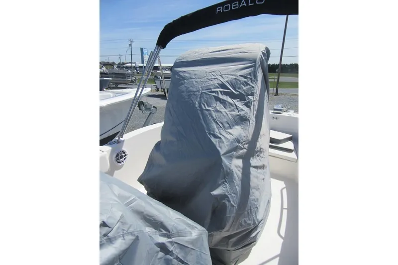Slide: The Image of 2023 Robalo R180 Center Console boat with covered console and seating area. - 24