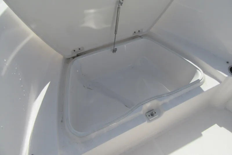 Slide: The Image of 2023 Robalo R180 Center Console storage compartment, open and empty. - 6
