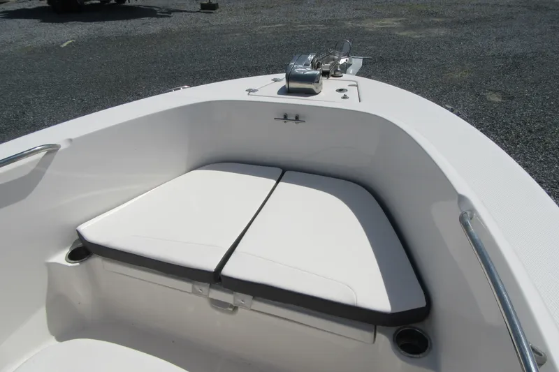 Slide: The Image of 2023 Robalo R180 Center Console boat bow seating area with white cushions. - 7