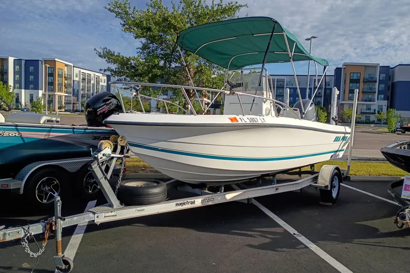 The Image of 2002 Sea Pro 190 Center Console boat on trailer, parked in urban setting. - 0