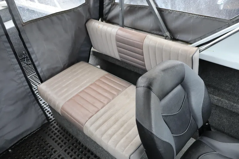 Slide: The Image of Interior seating of a 2006 Thunder Jet Luxor 19 boat, featuring cushioned seats. - 10