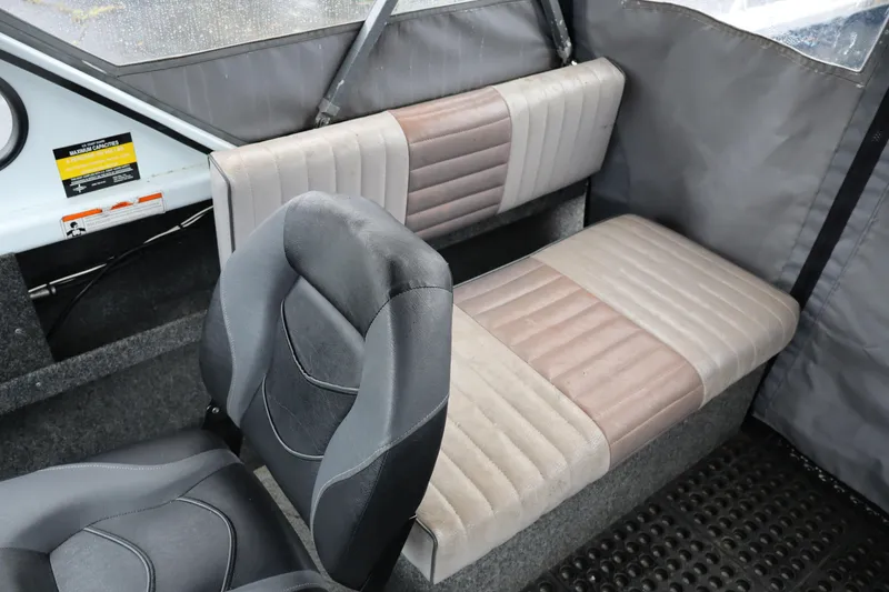 Slide: The Image of Interior of a 2006 Thunder Jet Luxor 19 boat with cushioned seating. - 11