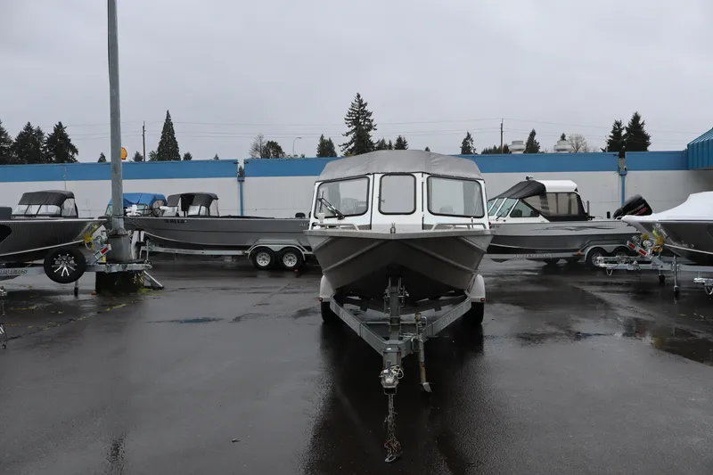 Slide: The Image of 2006 Thunder Jet Luxor 19 boat on trailer in a dealership lot. - 2