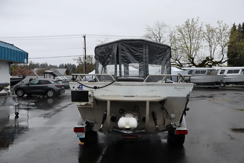 Slide: The Image of 2006 Thunder Jet Luxor 19 boat on trailer in rainy parking lot. - 4