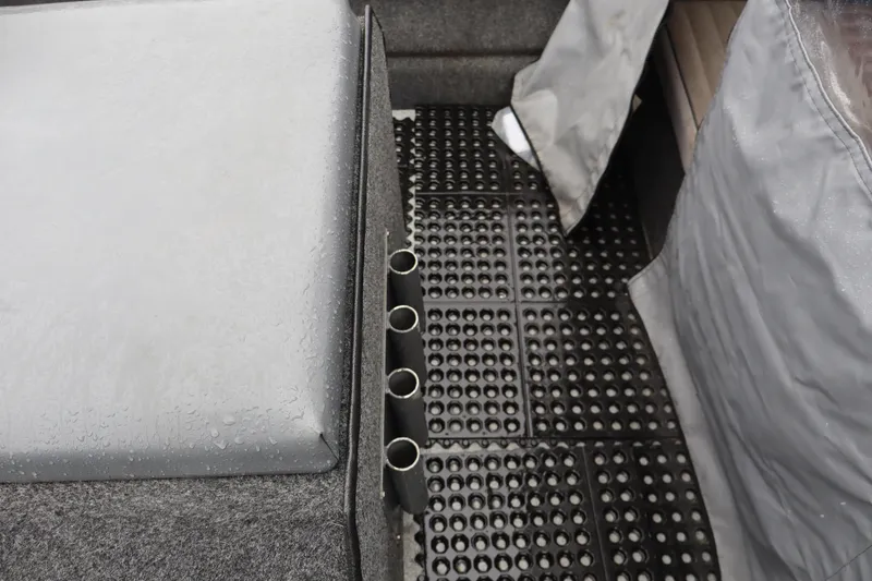 Slide: The Image of Interior of a 2006 Thunder Jet Luxor 19 boat with wet surfaces and rod holders. - 6