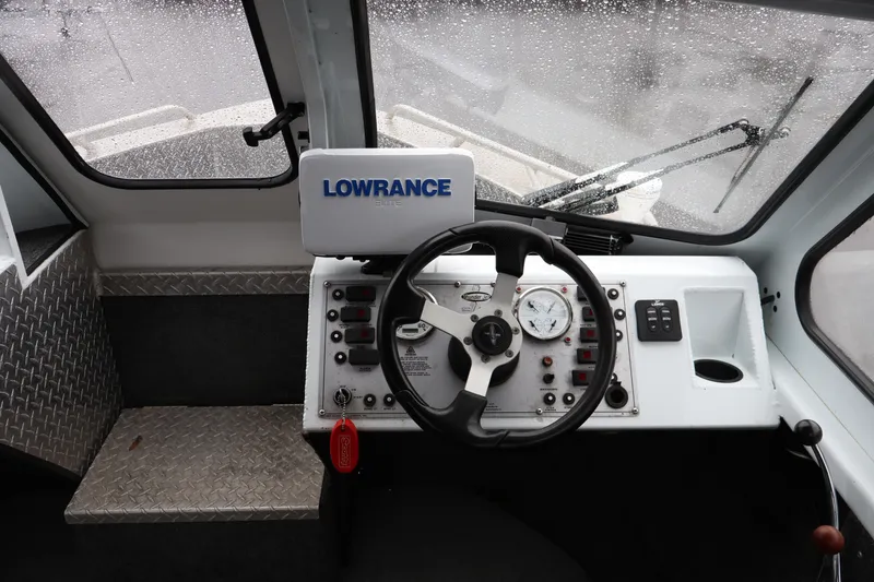 Slide: The Image of Interior cockpit of a 2006 Thunder Jet Luxor 19 boat with steering wheel and Lowrance navigation system. - 7