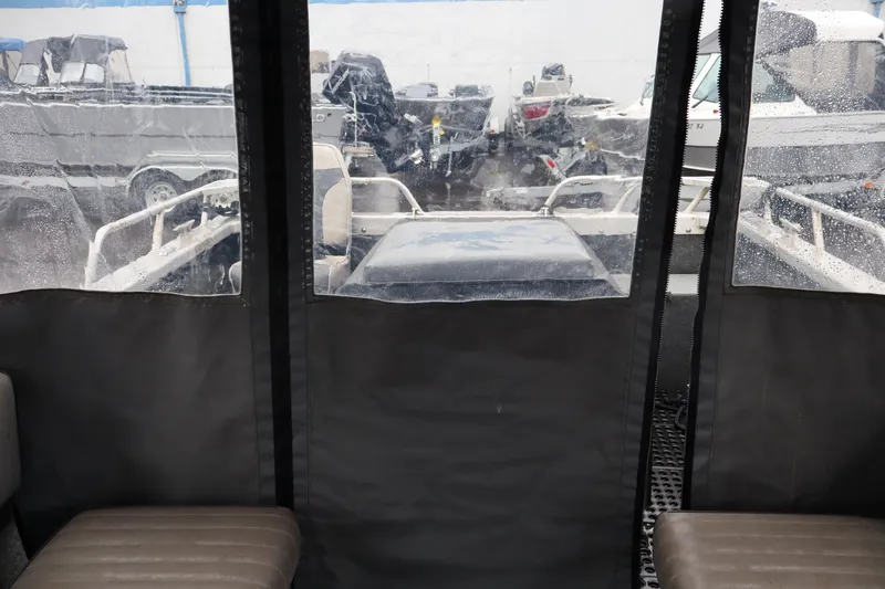 Slide: The Image of Interior view of a 2006 Thunder Jet Luxor 19 boat with rain-soaked windows. - 9