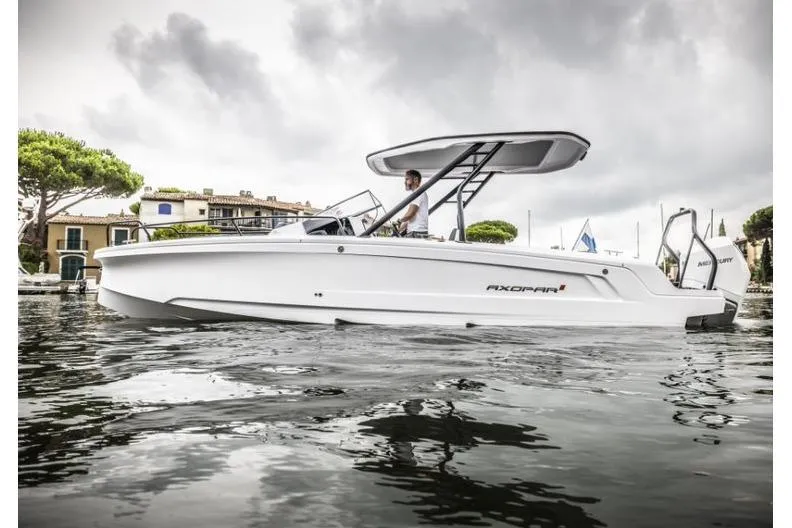 The Image of 2027 Axopar 25 Cross Top boat on water, sleek design, overcast sky. - 0