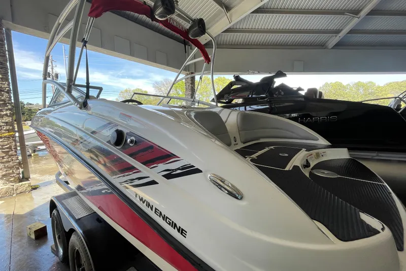 Slide: The Image of 2008 Yamaha Boats AR210 twin-engine boat in showroom, featuring sleek design and vibrant graphics. - 14