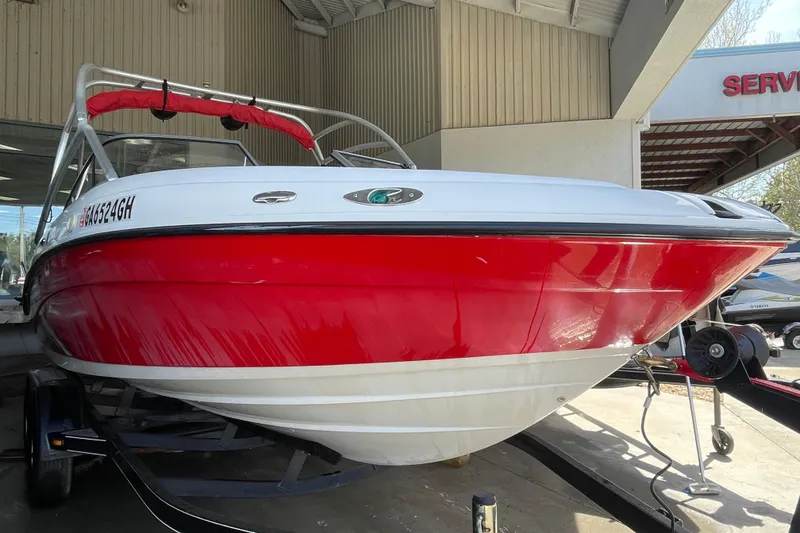 Slide: The Image of 2008 Yamaha AR210 boat with red and white hull on a trailer. - 15