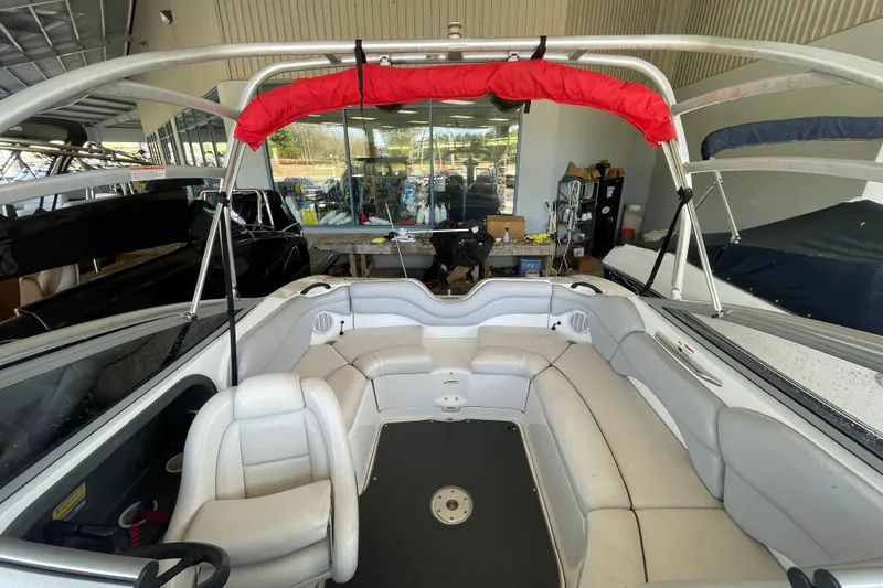 Slide: The Image of 2008 Yamaha Boats AR210 interior with white seating and red canopy in showroom. - 5