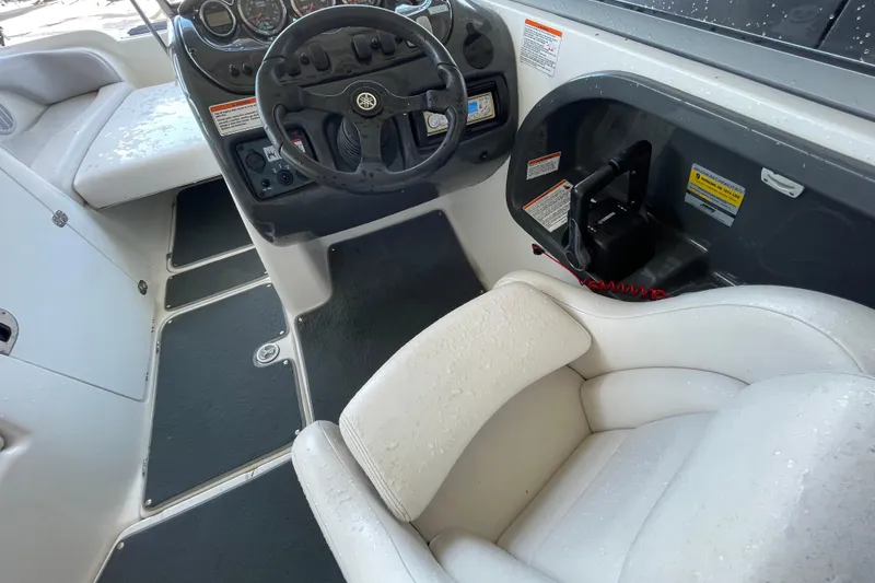 Slide: The Image of 2008 Yamaha AR210 boat interior with steering wheel and white seating. - 7