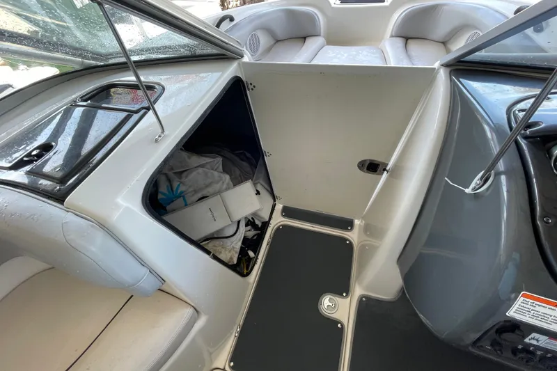 Slide: The Image of 2008 Yamaha AR210 boat interior with open storage compartment and seating area. - 9