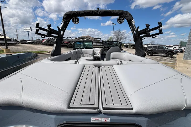 Slide: The Image of 2026 MB B52 23 Classic boat interior with gray seating and wakeboard racks. - 10