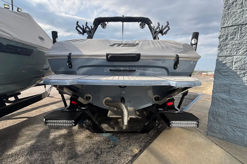 Slide: The Image of 2026 MB B52 23 Classic boat on trailer under cloudy sky. - 2