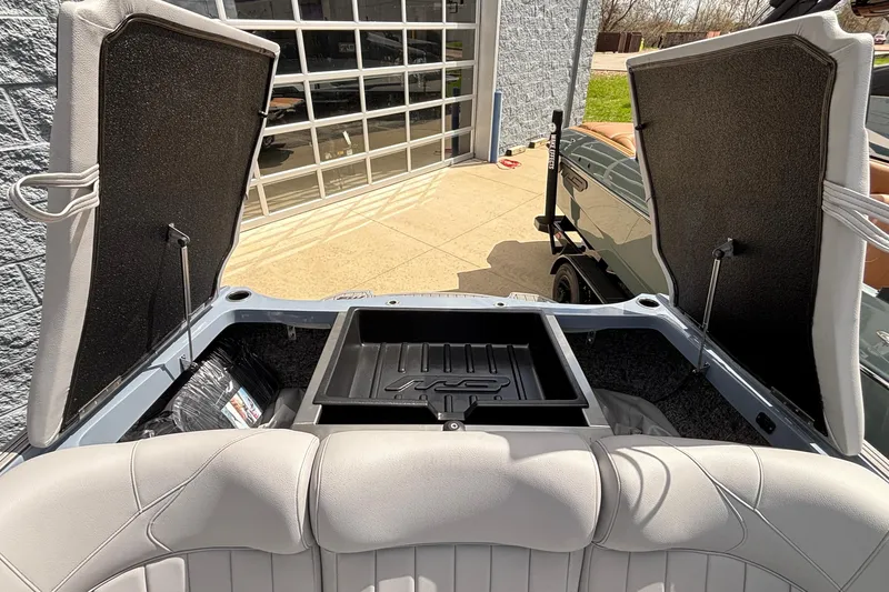 Slide: The Image of 2026 MB B52 23 Classic boat interior with open storage compartments and cushioned seating. - 26