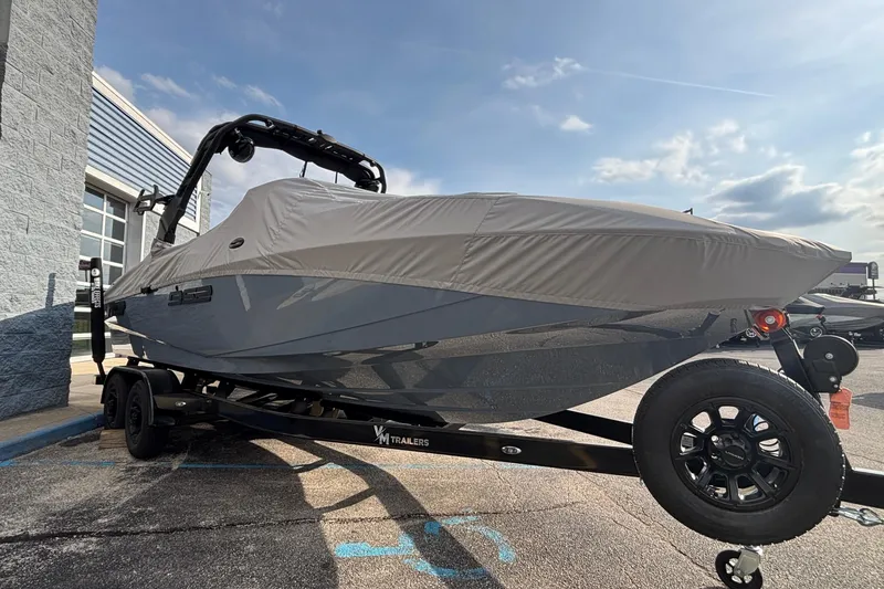Slide: The Image of 2026 MB B52 23 Classic boat covered on trailer under cloudy sky. - 5