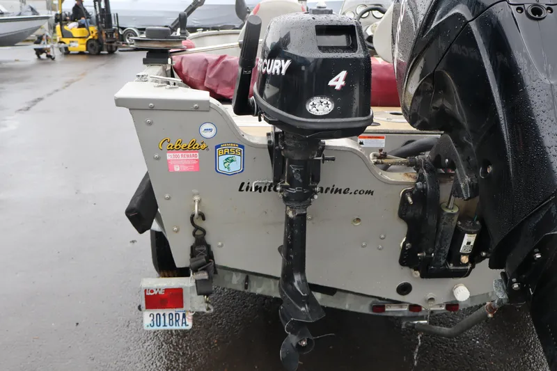 Slide: The Image of 2009 Lowe Fishing Machine 165 with Mercury outboard motor, parked on wet pavement. - 5