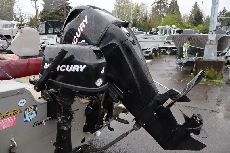 Slide: The Image of 2009 Lowe Fishing Machine 165 with Mercury outboard motor in a boatyard setting. - 6