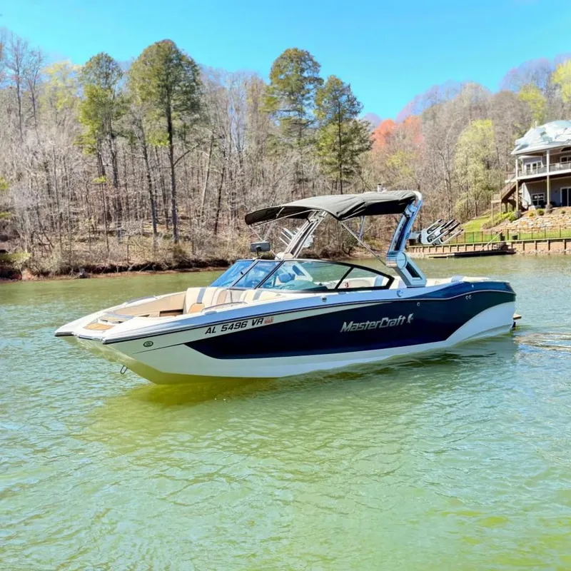 The Image of 2022 MasterCraft X24 boat on a serene lake. - 0