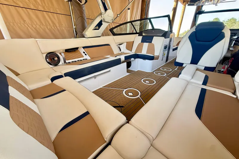 Slide: The Image of Luxurious interior of a 2022 MasterCraft X24 boat with plush seating and elegant design. - 12