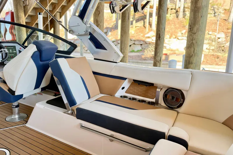 Slide: The Image of 2022 MasterCraft X24 boat interior with luxurious seating and modern dashboard. - 15