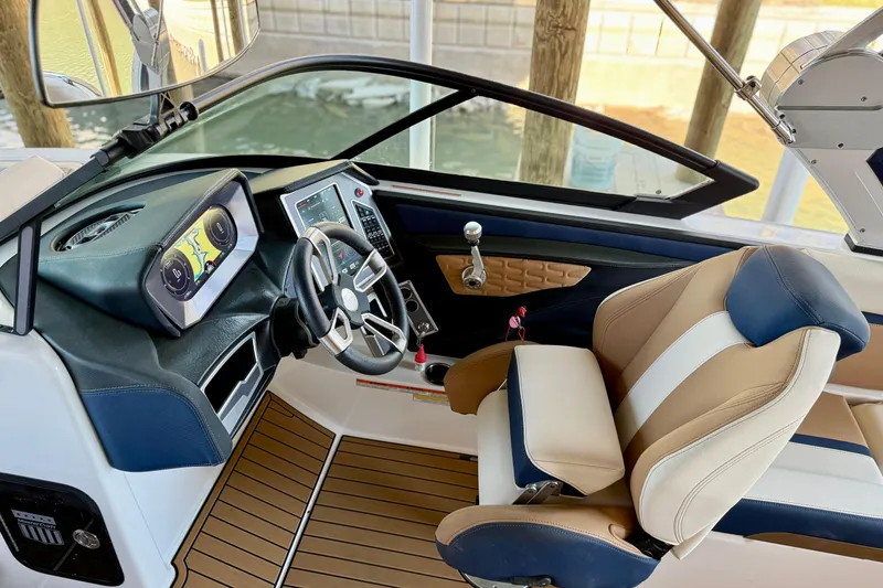 Slide: The Image of 2022 MasterCraft X24 boat cockpit with modern controls and luxurious seating. - 16