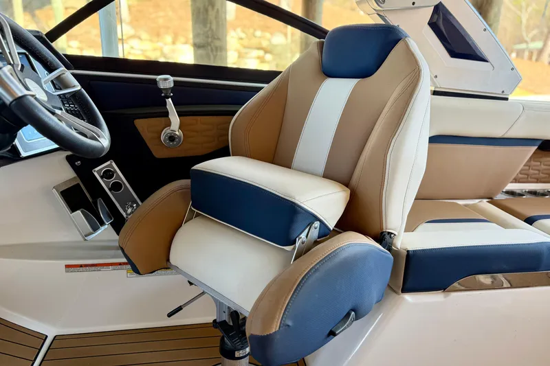 Slide: The Image of 2022 MasterCraft X24 boat interior with luxurious captain's seat and steering wheel. - 18