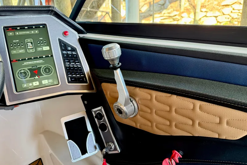 Slide: The Image of 2022 MasterCraft X24 boat dashboard with touchscreen controls and throttle lever. - 20