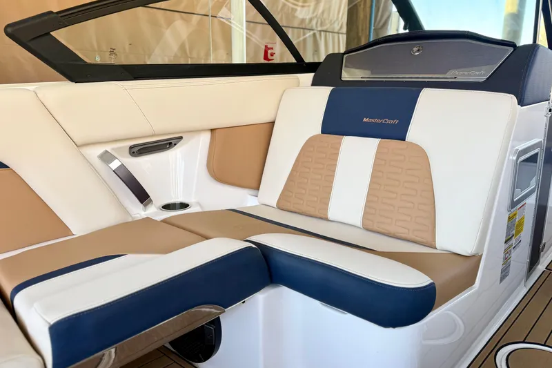 Slide: The Image of Luxurious interior seating of 2022 MasterCraft X24 boat with beige and navy accents. - 21