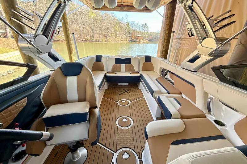 Slide: The Image of Interior of a 2022 MasterCraft X24 boat with luxurious seating and lake view. - 27