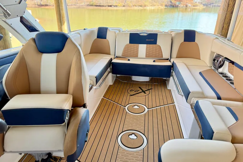 Slide: The Image of 2022 MasterCraft X24 boat interior with luxurious seating and stylish wood flooring. - 28