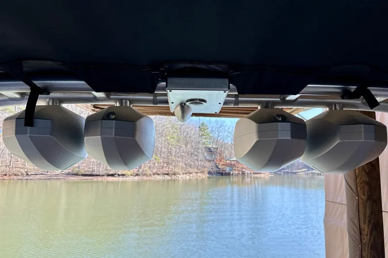 Slide: The Image of 2022 MasterCraft X24 boat speakers overlooking a serene lake view. - 30
