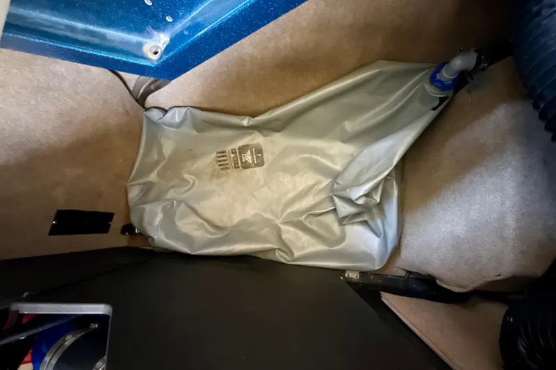 Slide: The Image of 2022 MasterCraft X24 interior with gray storage bag on carpeted floor. - 33