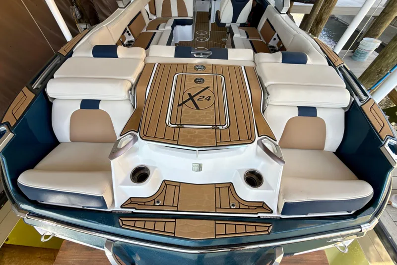 Slide: The Image of 2022 MasterCraft X24 boat interior with luxurious seating and stylish design. - 38