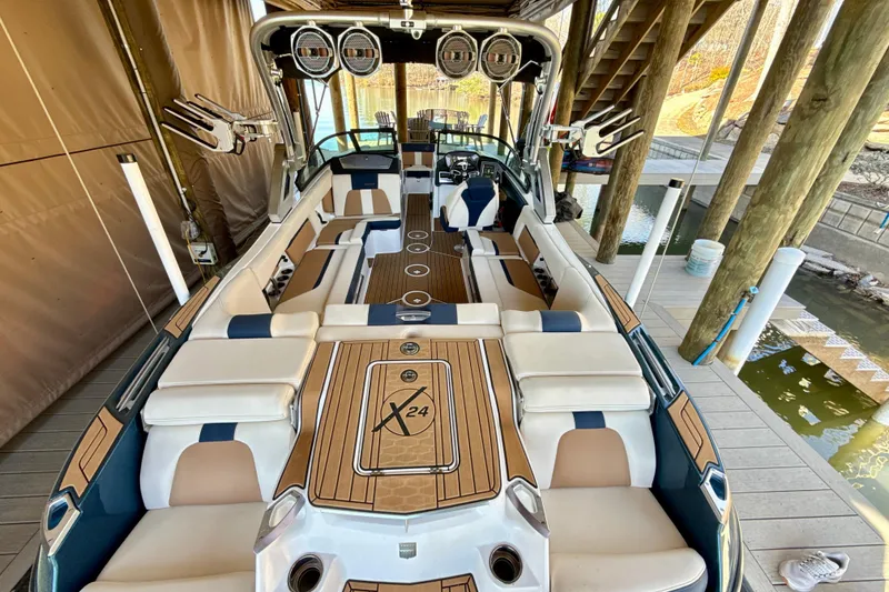 Slide: The Image of 2022 MasterCraft X24 boat interior with luxurious seating and modern design. - 8