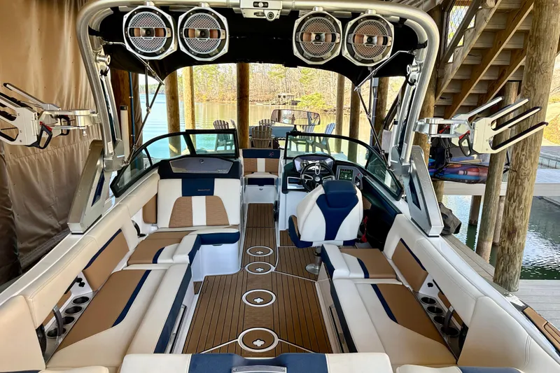 Slide: The Image of 2022 MasterCraft X24 boat interior with luxury seating and advanced audio system. - 9