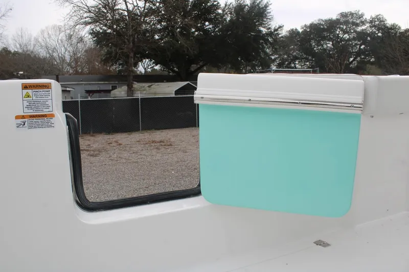 Slide: The Image of 2026 Sea Fox 268 Commander boat interior with teal panel and warning labels. - 16