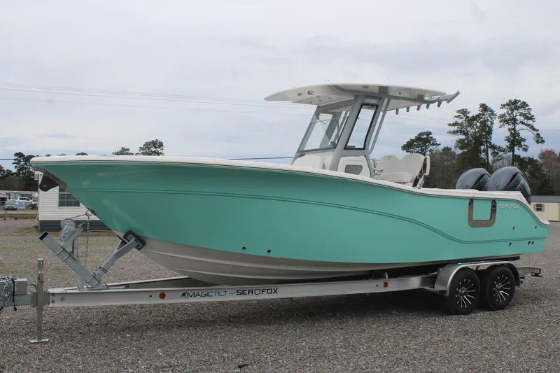 Slide: The Image of 2026 Sea Fox 268 Commander boat on trailer, mint green hull, dual engines. - 3