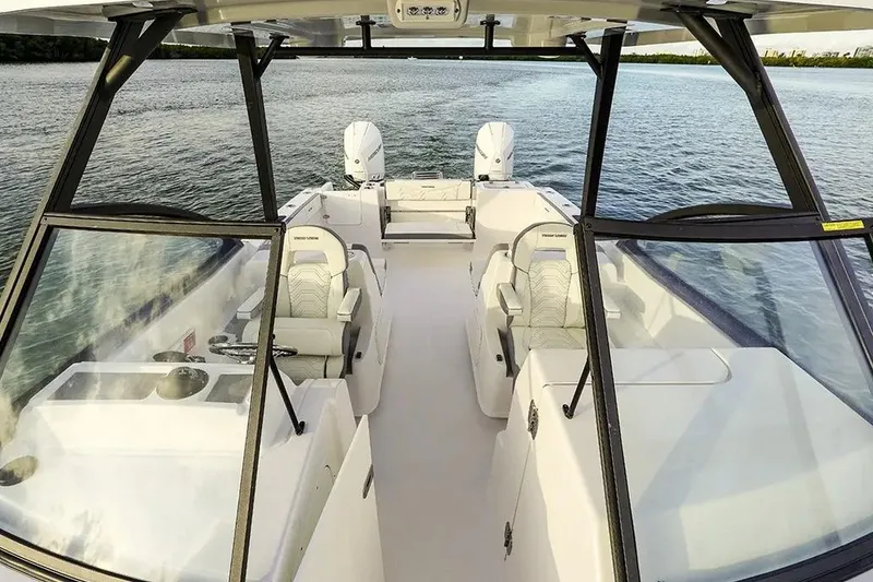 Slide: The Image of Manufacturer Provided Image: 2026 Twin Vee 280 GFX2 DC boat interior with seating, on calm water. - 2