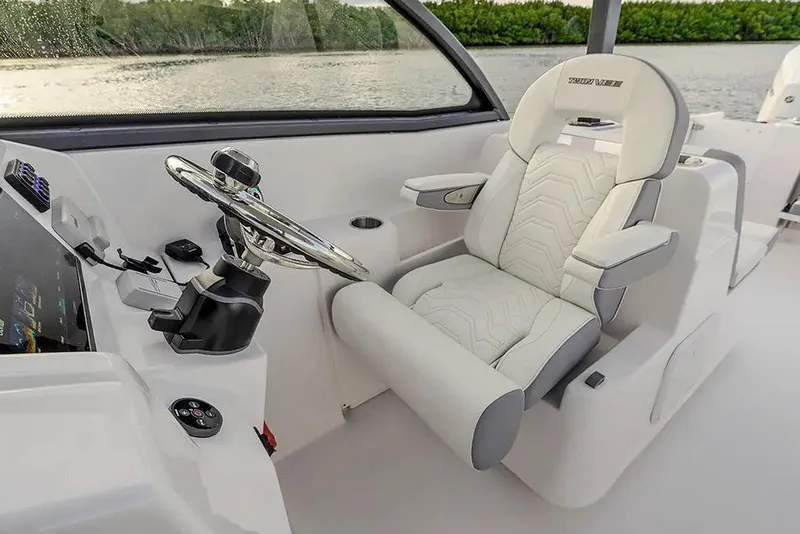 Slide: The Image of Manufacturer Provided Image: 2026 Twin Vee 280 GFX2 DC boat interior with modern steering and luxurious seating. - 3