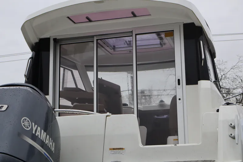 Slide: The Image of 2015 Jeanneau Merry Fisher 755 boat with Yamaha engine, rear view. - 5
