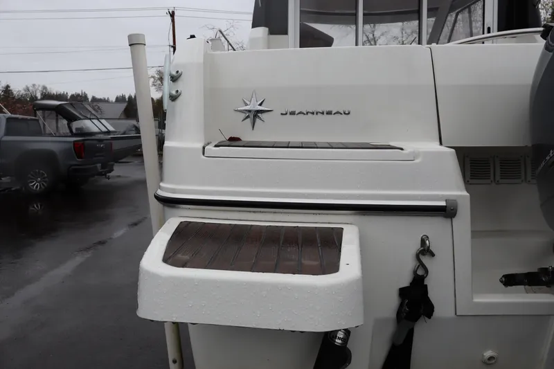 Slide: The Image of 2015 Jeanneau Merry Fisher 755 boat stern with logo and swim platform. - 6