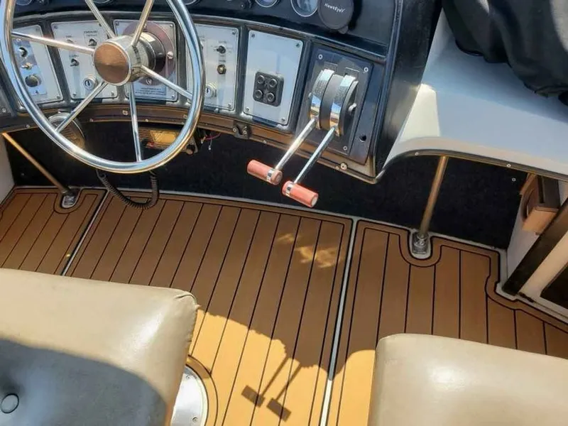 Slide: The Image of 1983 Carver 3207 Aft Cabin helm with wooden flooring. - 5