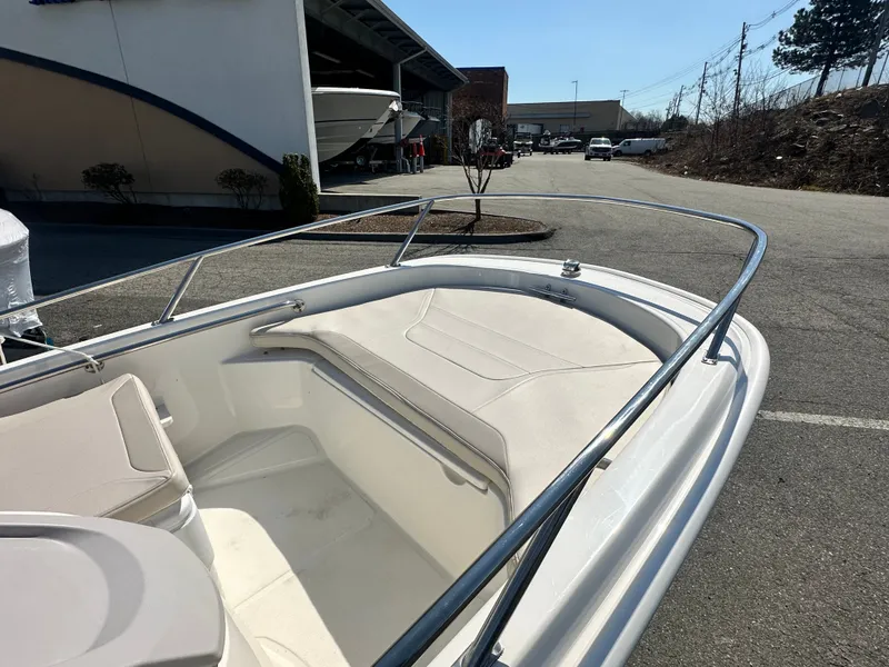 Slide: The Image of 2019 Boston Whaler 130 Super Sport boat parked outdoors. - 1