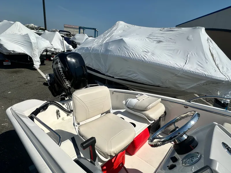 Slide: The Image of 2019 Boston Whaler 130 Super Sport boat with Mercury engine. - 3
