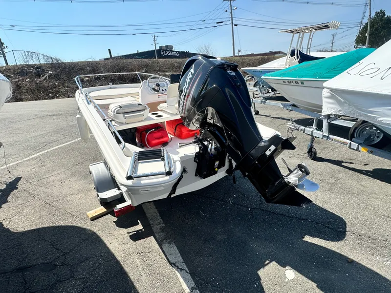 Slide: The Image of 2019 Boston Whaler 130 Super Sport boat in a parking lot. - 5